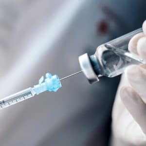 Injecting,injection,vaccine,vaccination,medicine,into,a,syringe,woman,nurse